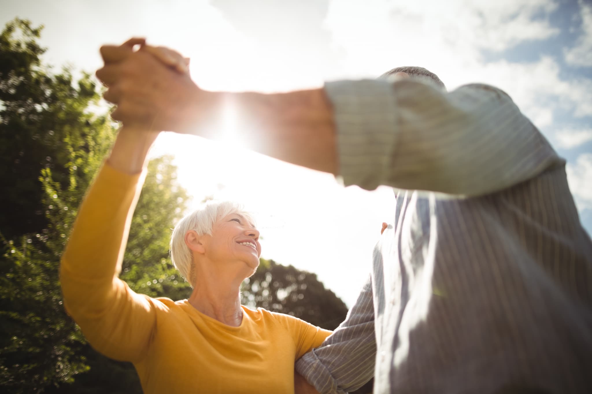 Photographie d'un homme senior et d'une femme senior en couple qui danse.